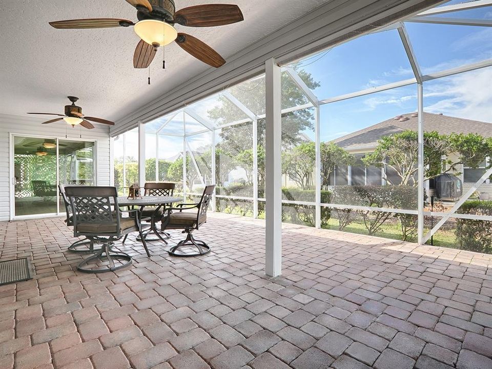 Expanded screened lanai.  Patio table and 4 chairs stay with property