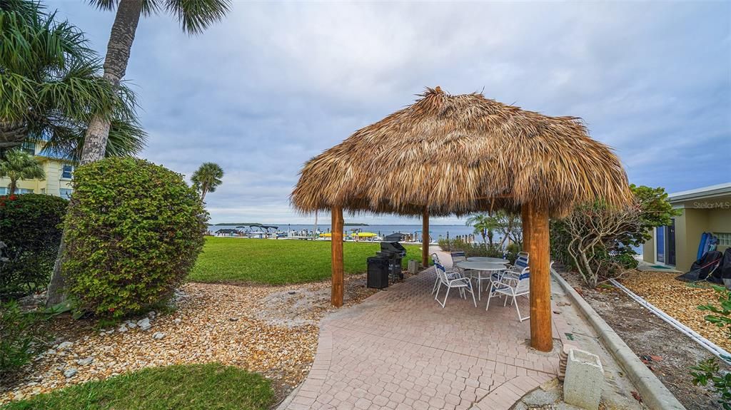 tiki hut onsite on the bayside, with grill and sitting area