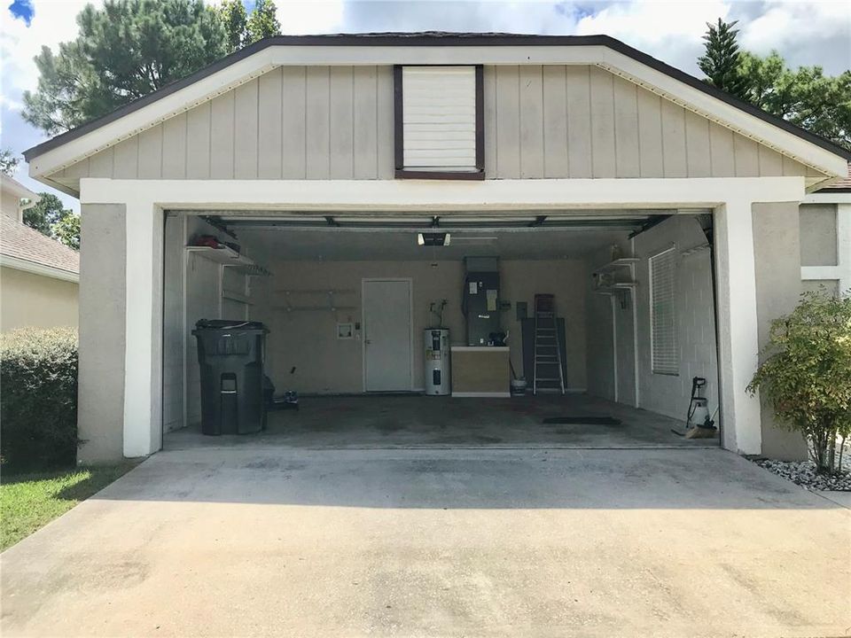 Full-size double garage accommodates two cars and extra storage at right of a/c.