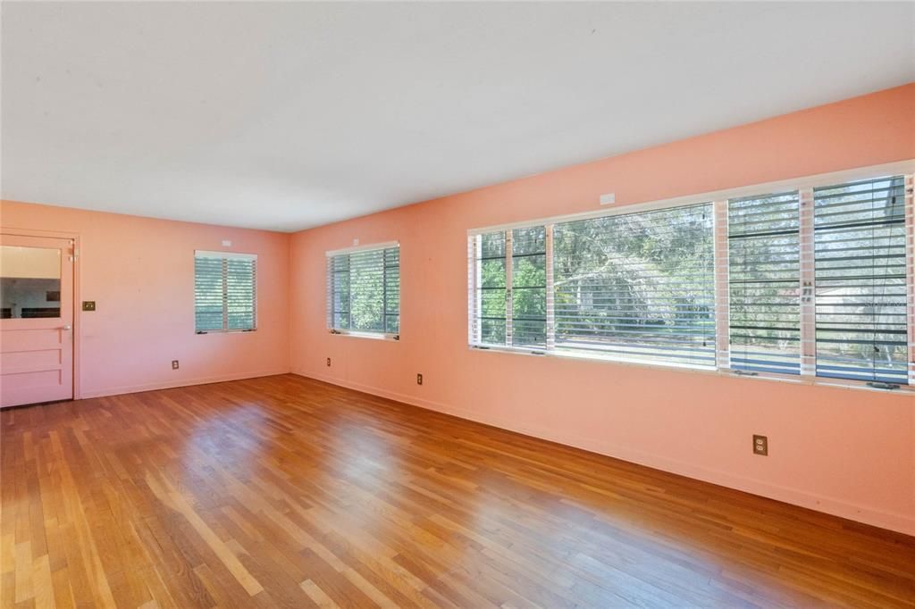 Large Dining Room with Lots of Windows Adding Natural Light. Door Leads Down to Your Indoor Laundry Room/Pantry Area.