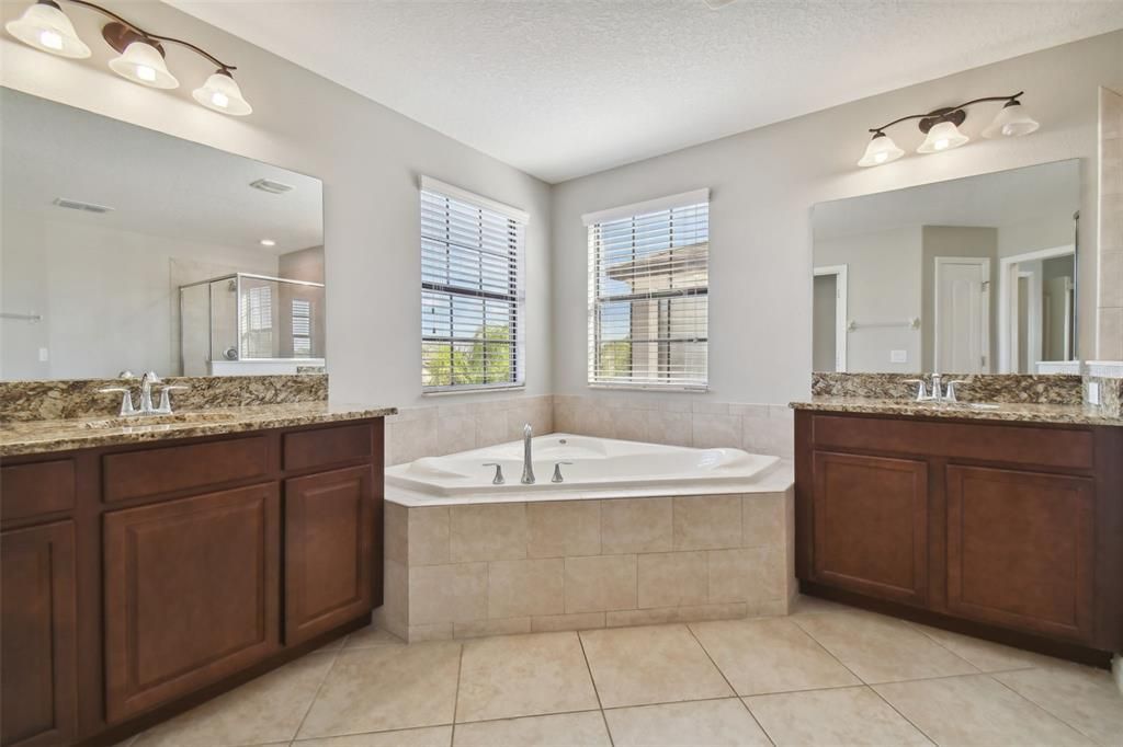 Master ensuite his and hers vanities and garden tub.