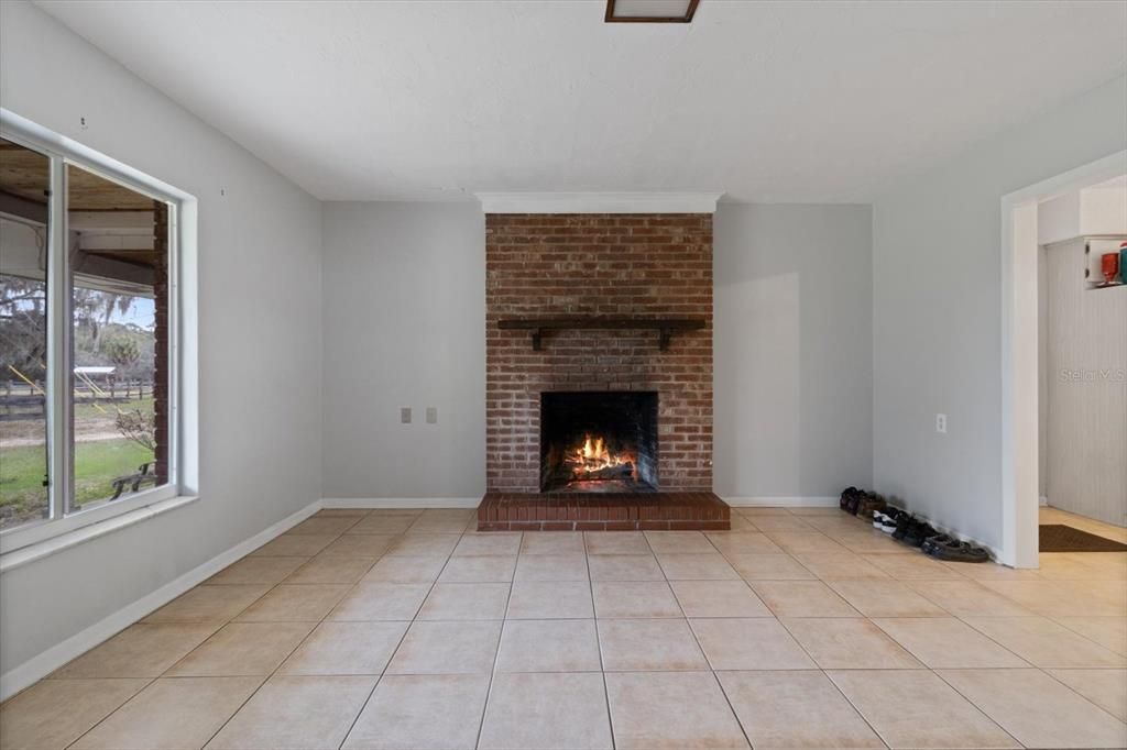 Family room/dining room with brick fire place. Virtual Fire in Fireplace