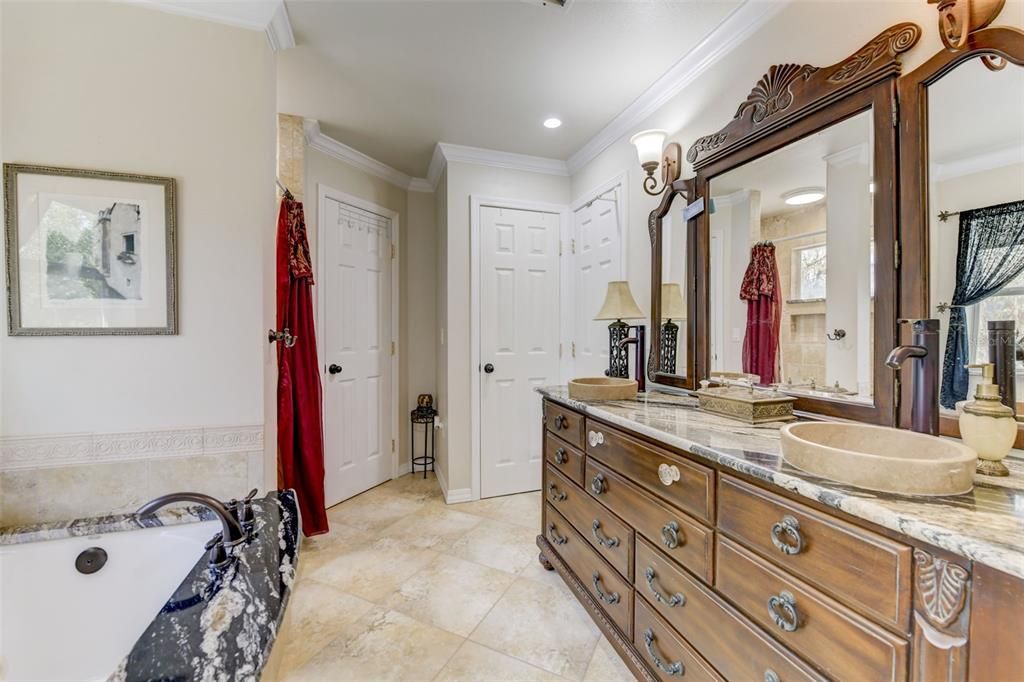 Enjoy relaxing in your incredible master bathroom with incredible tub, large shower and his/her sink in exquisite custom cabinetry