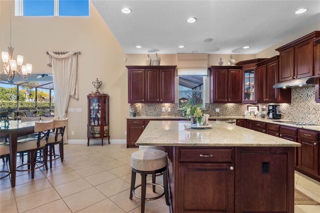 Kitchen with view of casual dining area and outdoor lanai just to the left.