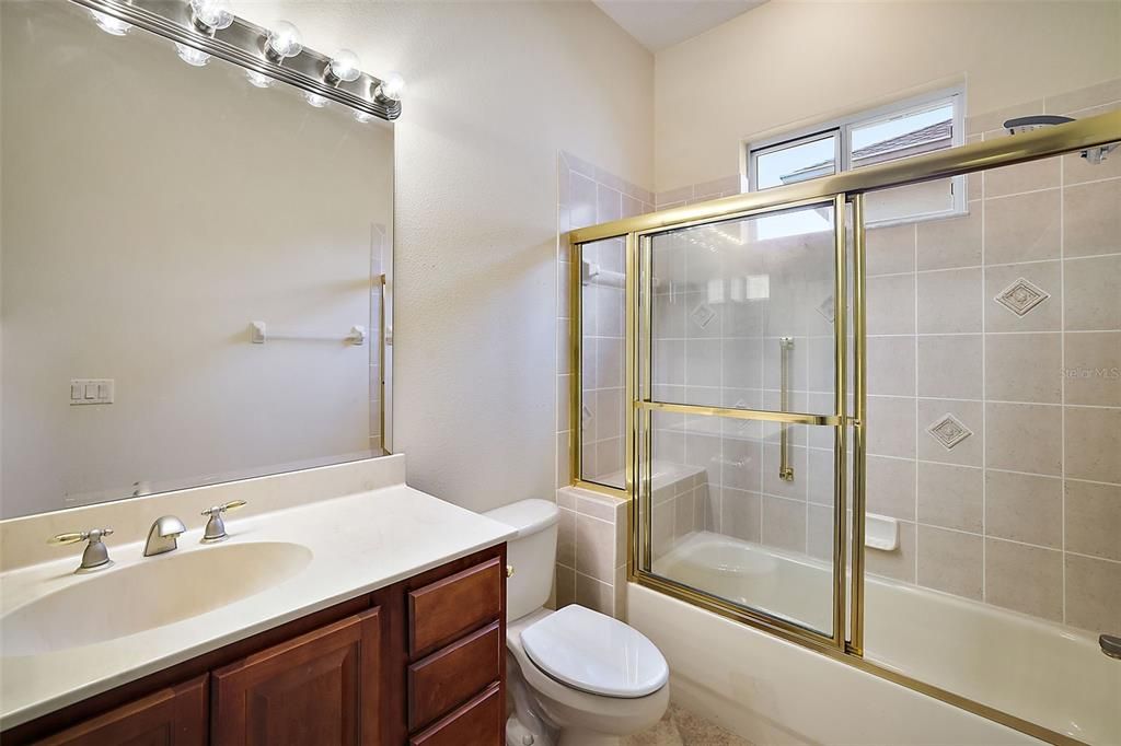 Guest Bathroom with a Pocket door to the guest room.