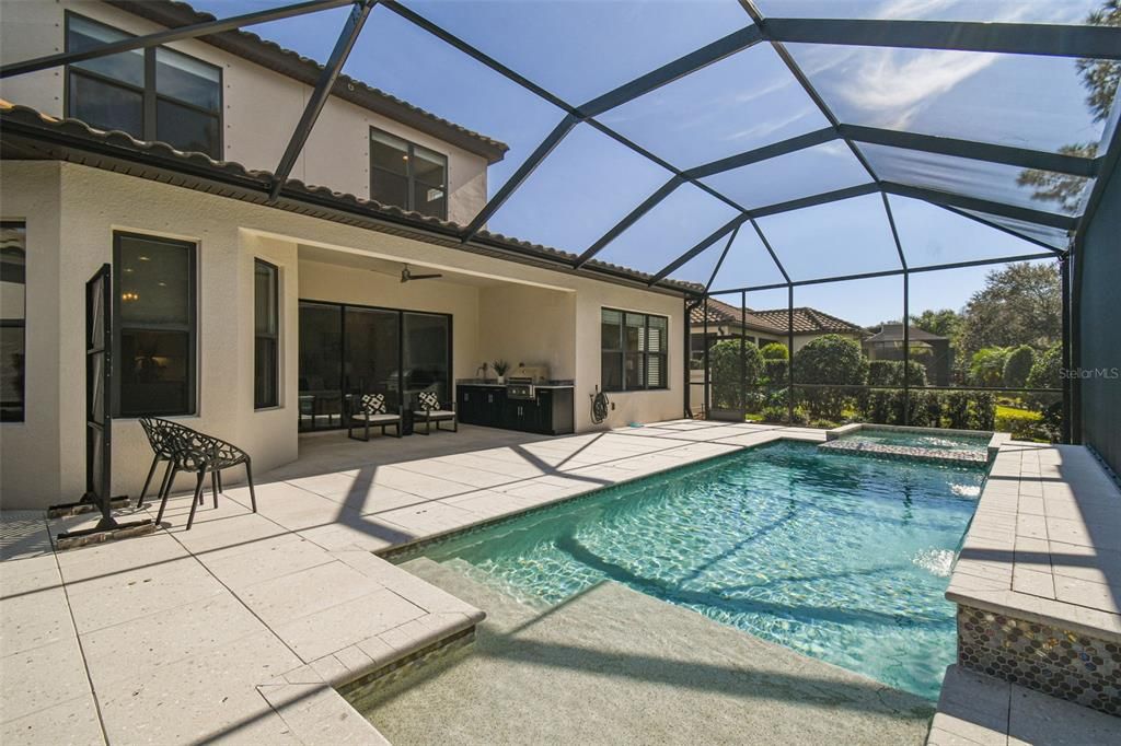 The pool has a sun shelf and 2 waterfalls.