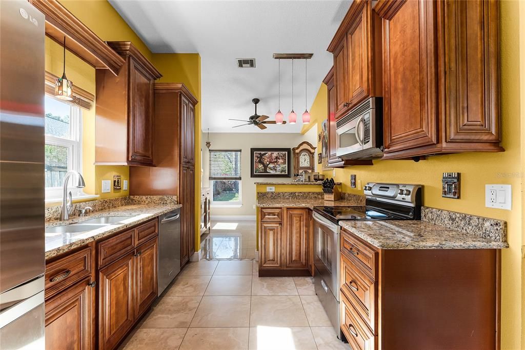 The kitchen features solid wood cabinetry, granite counters and stainless appliances.