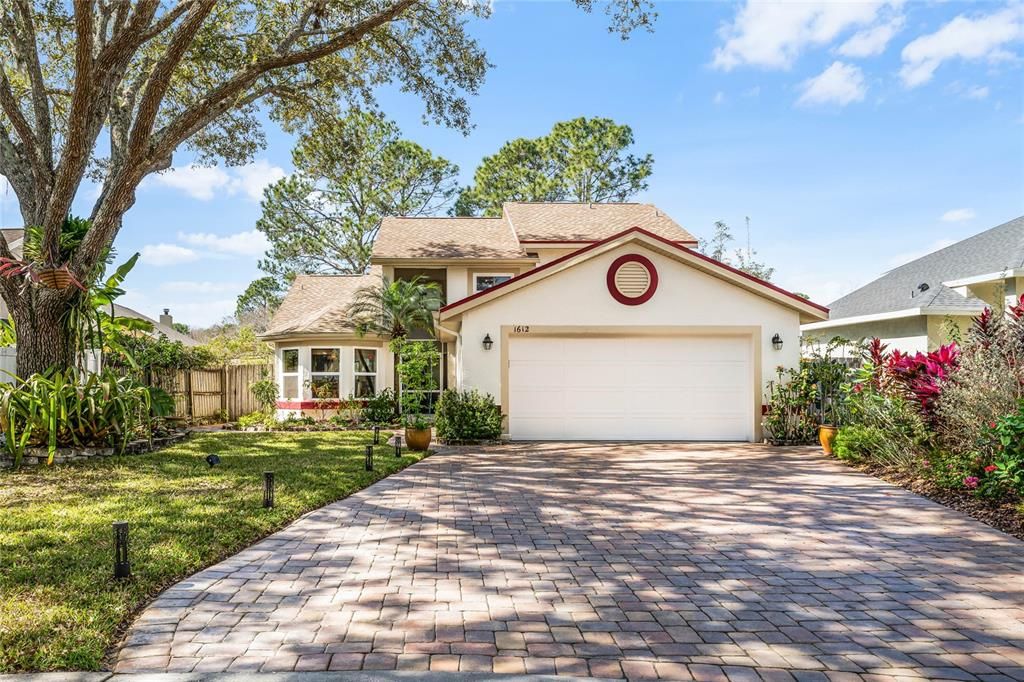This home features mature landscaping with native Florida foliage, fruit trees and oak.