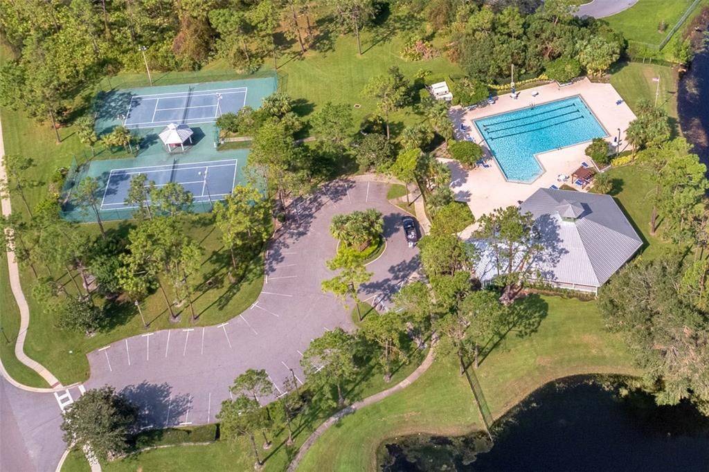 Birdseye view of the community clubhouse, pool and tennis courts.