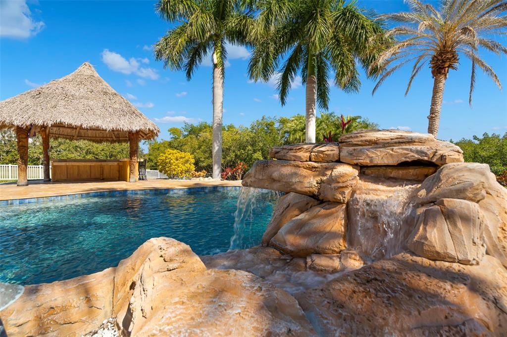Tropical oasis in  your back yard with two waterfalls and your own Tiki Bar.