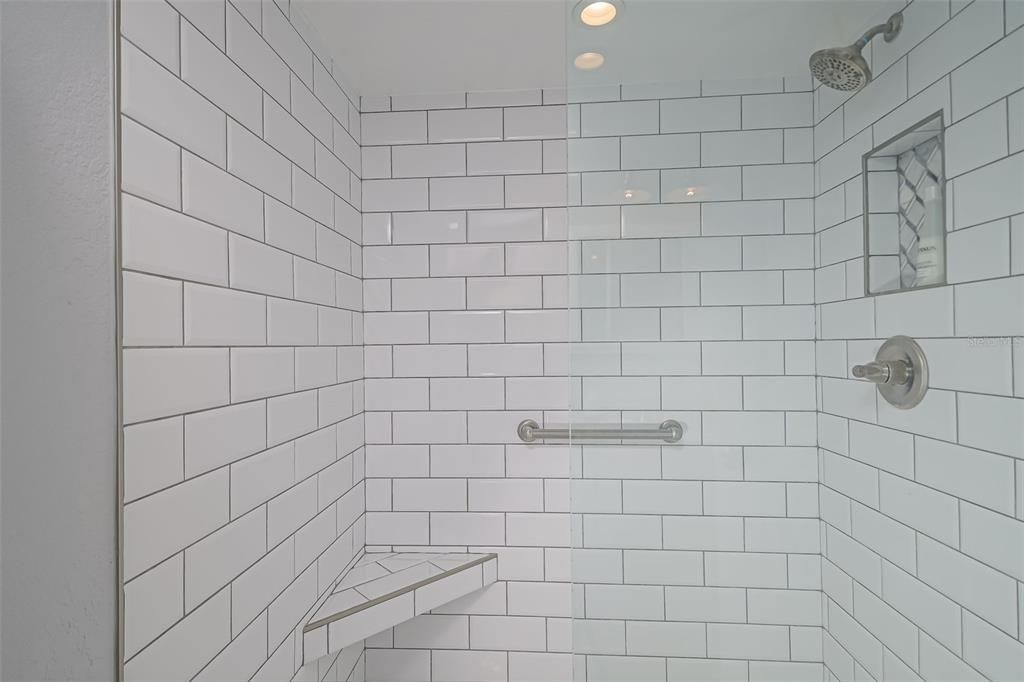 Beautiful walk-in shower with bright tile.