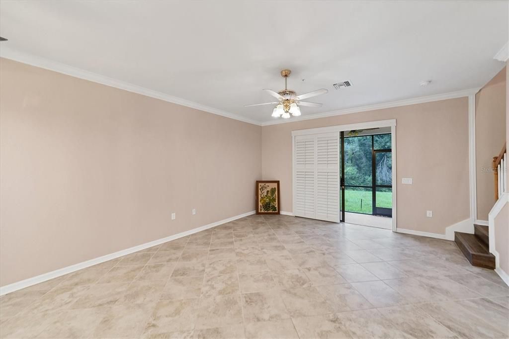 Living Area Shows Plantation Shutters Open to Screened Lanai