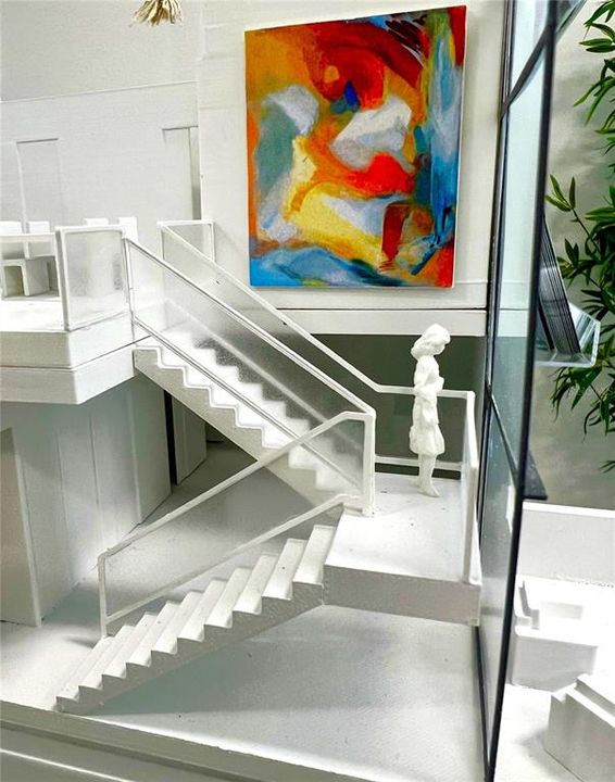 Model depicts the sweeping open staircase complimented by soaring 26-foot ceiling heights