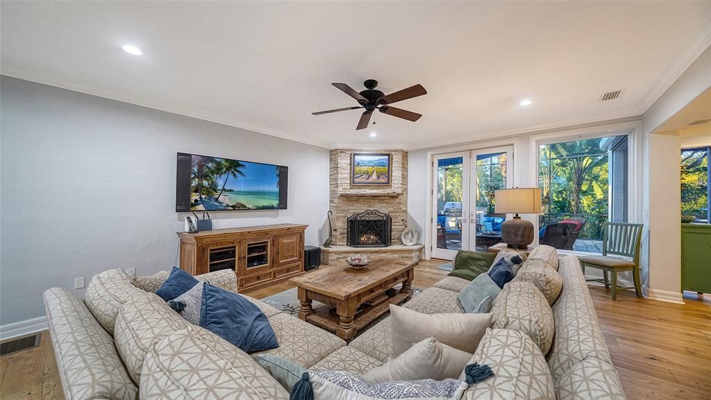 Family room with wood burning fireplace, French doors to the patio and adjacent to the Kitchen