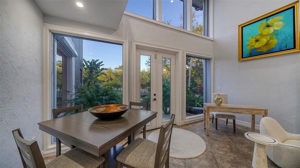 Volume ceiling in the living room with French doors and wall of glass