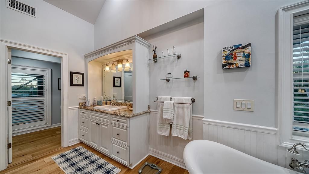 Large main suite bath currently used as hers.   Ceramic tub, full walk in shower and walk in custom closet