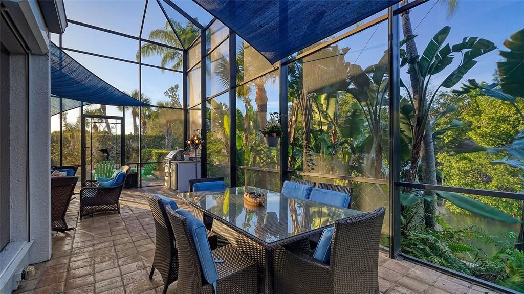 View from dining to sitting area along the canal.  Volume screened cage brings the outdoors inside