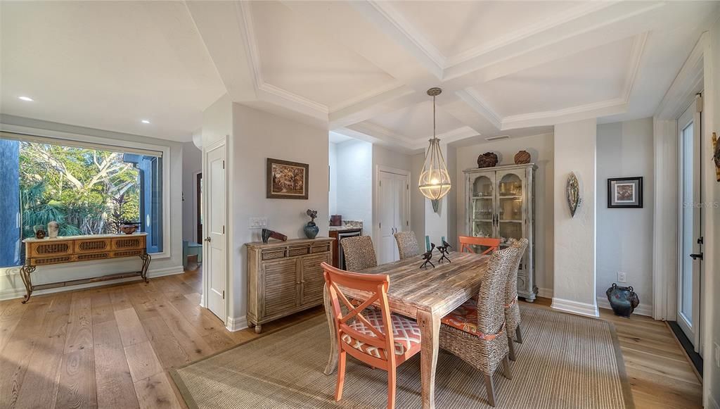 Formal dining with architectural detailed ceilings and beautiful wood flooring