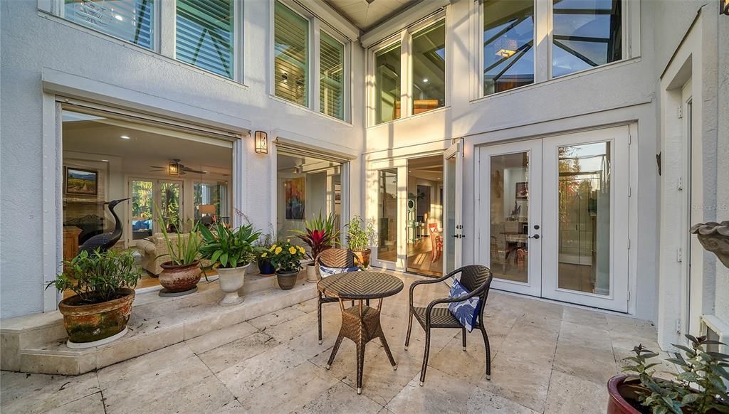 Screened Atrium adjacent to the family room and with French doors to the dining room.