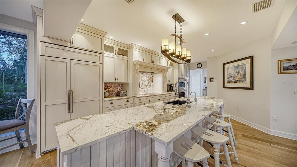 Kitchen with center island and plenty of sitting places to engage with your guest