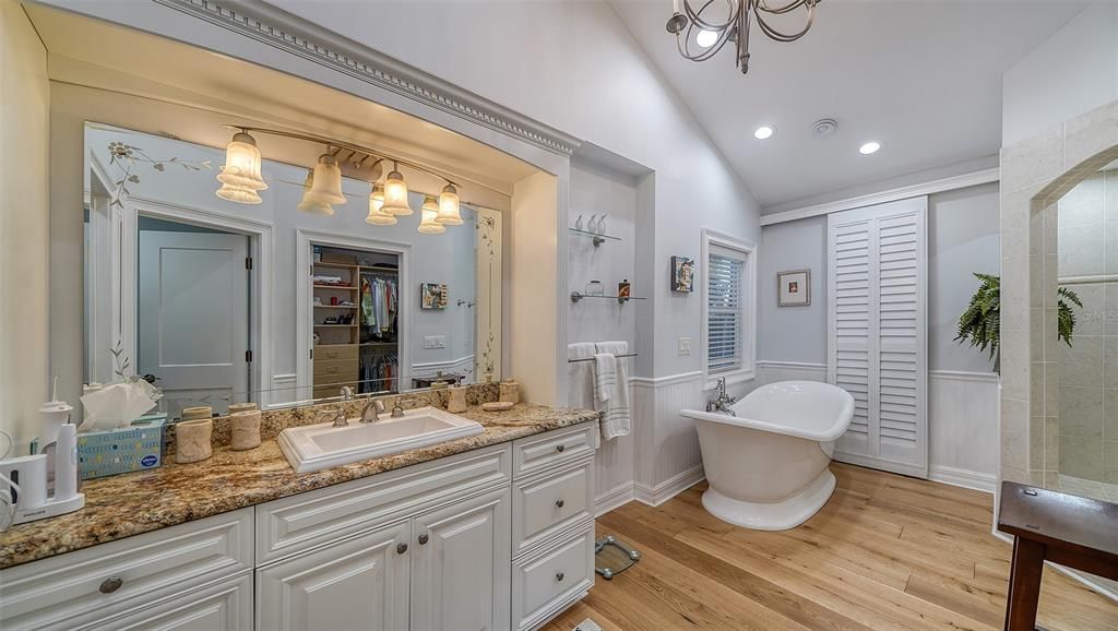 Her main suite bath,  wood floors, separate tub and shower, walk in closet with custom finishes