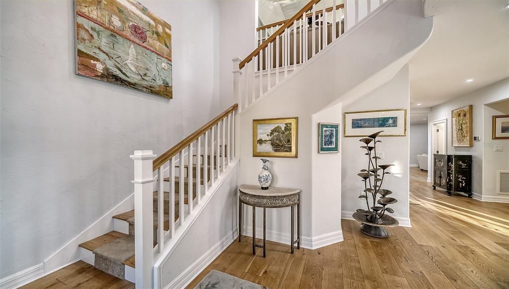 Foyer entrance showcasing the wood staircase and the Oak flooring throughout the house