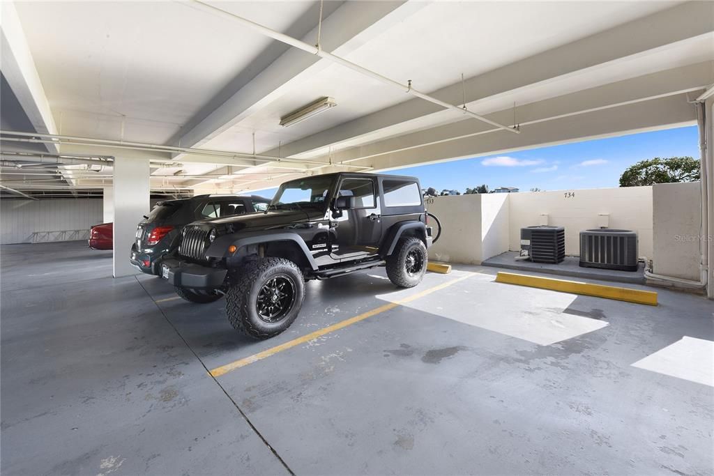 Parking space covered under building where the Jeep is.