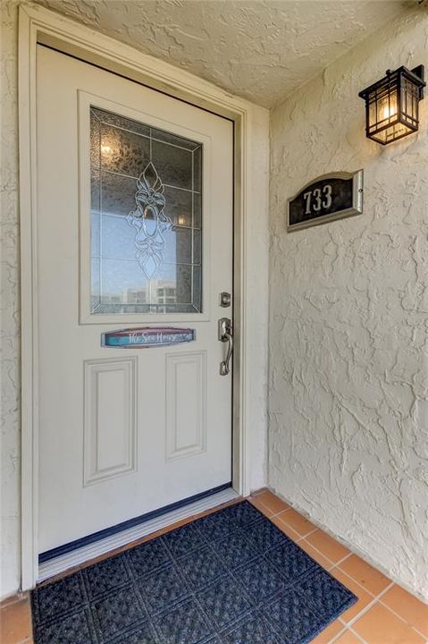 inviting entry lead glass front door to condo