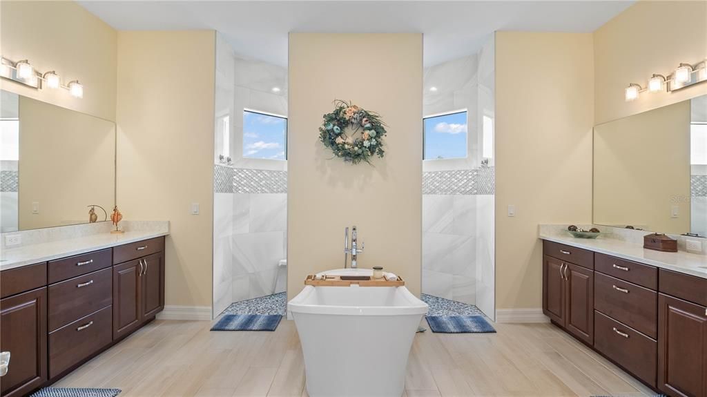 Master Bathroom - Double his and hers vanities- quartz countertops, garden tub and large dual entry walk in shower. Custom tilework reallyadds a serene vibe to the bathroom!