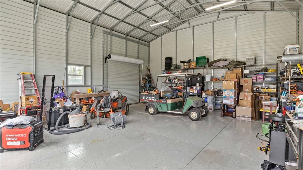 Workshop - Very soundly built and NOFLOODING during Ian, this property sits up high and has very reasonable insurance with NO FLOOD required by Lender. Ceilings are 16foot tall, three rollup doors as well as side entry door and epoxy floors!