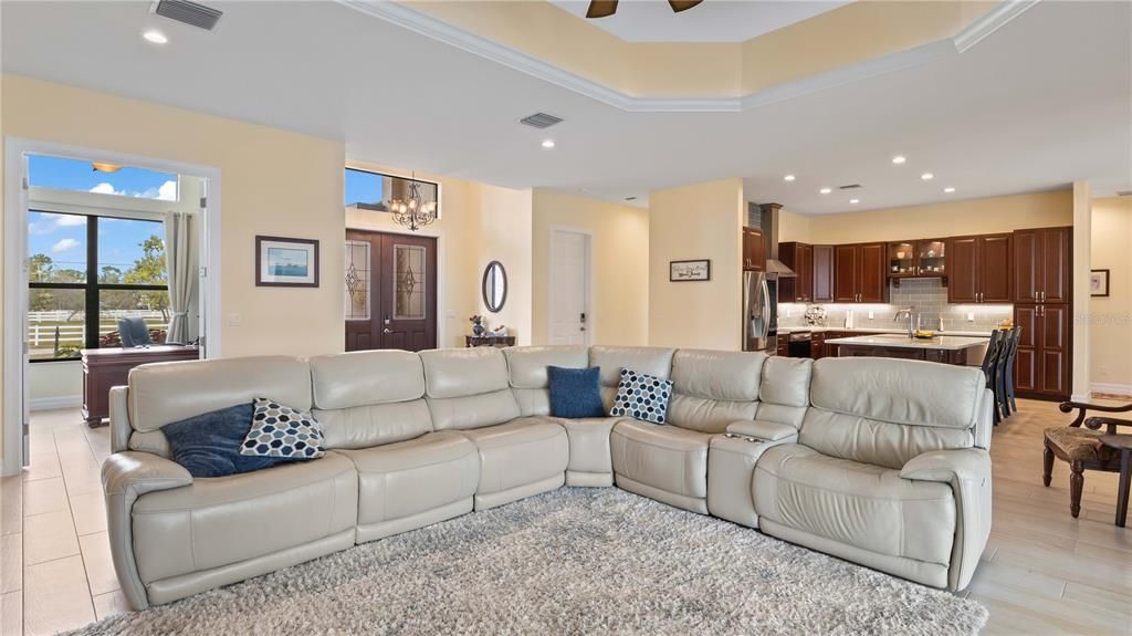 Great Room - Great room is the heart of the home and can easily large furniture layouts! Inground electrical outlet, 2 foot tray lighted ceiling, triple sliders to the outside - a perfect layout!
