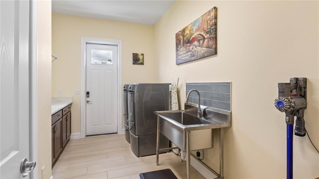 Laundry - Not very often we highlight a laundryroom but this one is both functional and fun -tons of additional storage space, an oversized free standing laundry tub and private access to the outside - and plenty of room to add additional storage!