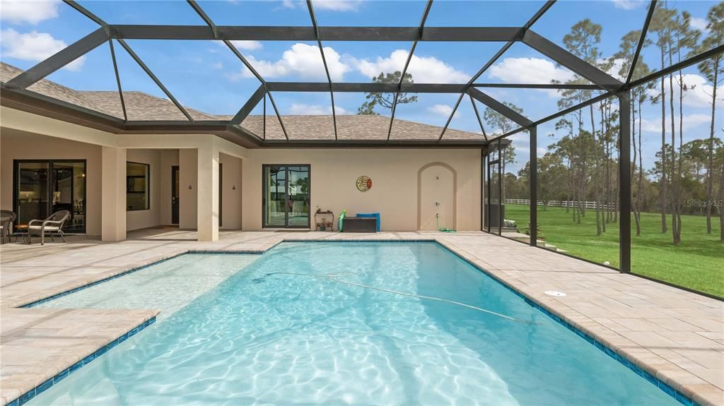 Pool - Supersized pool, supersized home, supersized lot! Picture window reinforced screens to maximize the view! Enjoy the pool year round and our average winter temperatures of 74 degrees!!