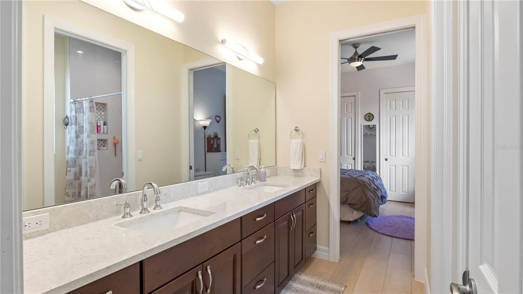 Bathroom - Jack and Jill bath between the two guest rooms with dual vanities, wall to wall mirrors and lots of cabinet space. Bath and shower combo with tile niches and private water closet!