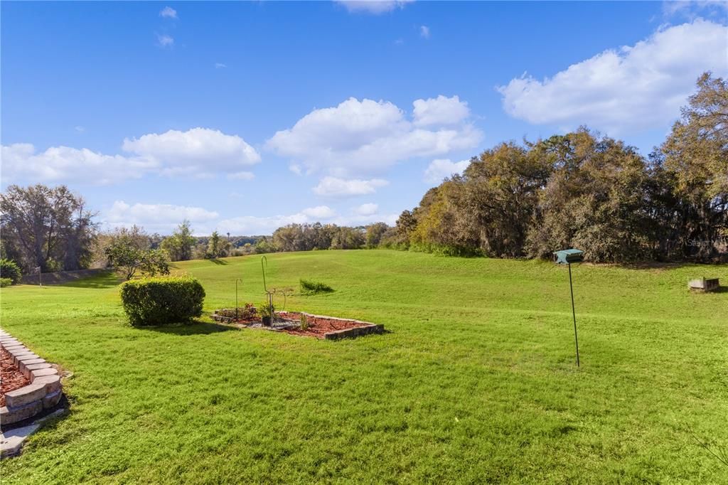 View of the back yard and grounds behind the yard