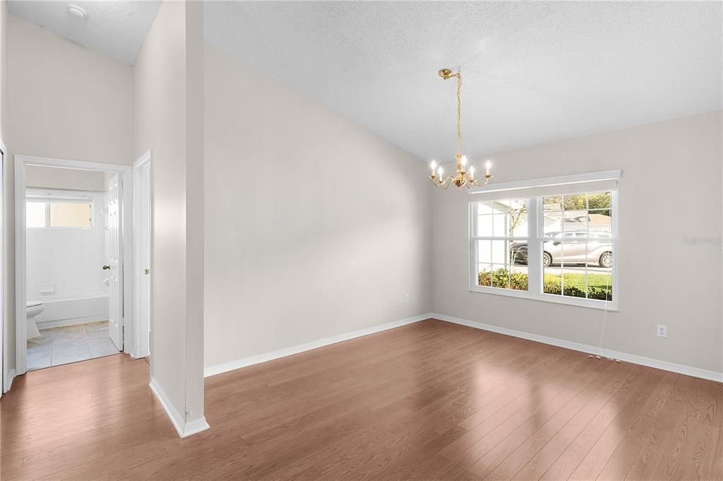 View from foyer showing dining room and entry to 2nd bath & bedroom