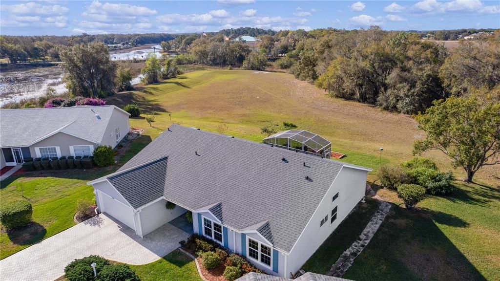 Aerial view of the home and grounds behind the home