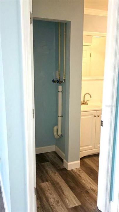 Laundry hookups in bathroom closet for a stackable unit