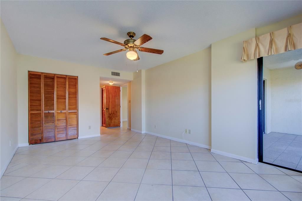 master bedroom view of walking closet and balcony to the right master bath is through door