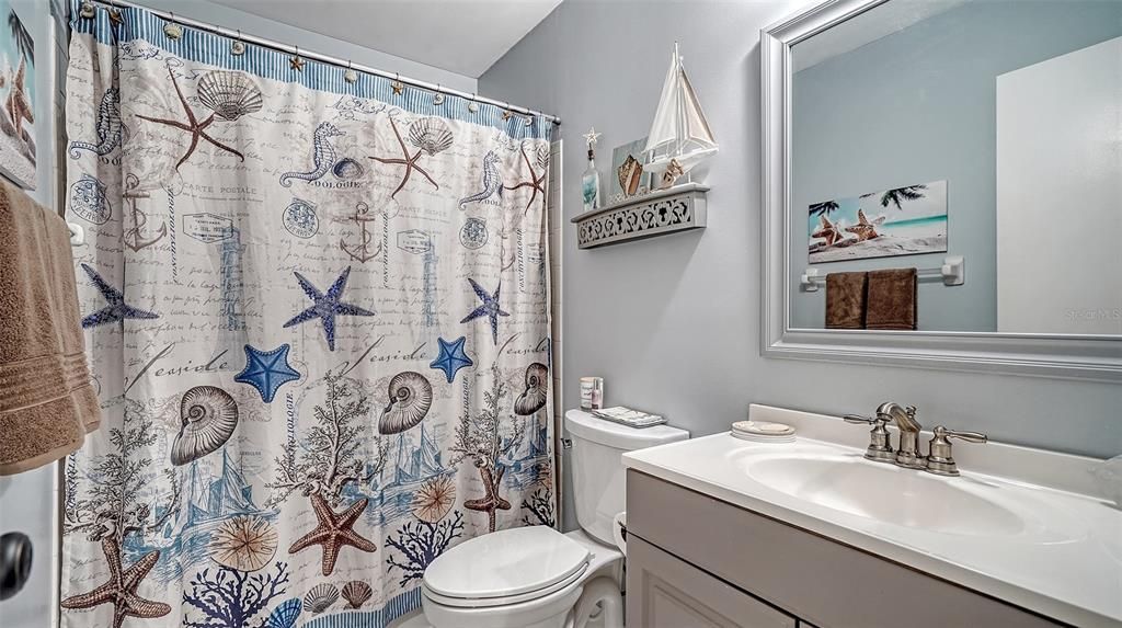 The guest bathroom offers a tub/shower combination and an updated single vanity.