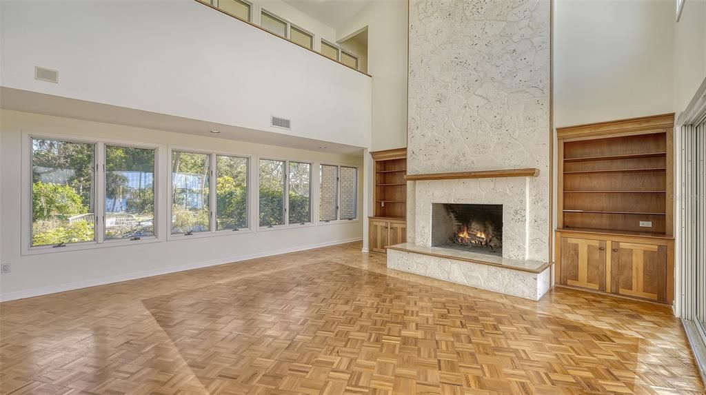 Large wood burning fireplace surrounded by floor to ceiling coralstone tile.