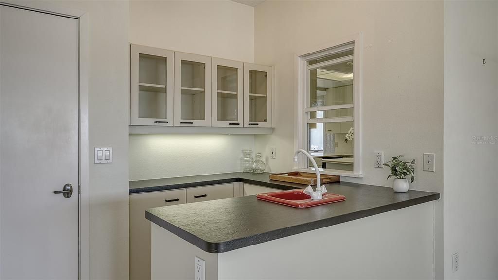 Family Room wet bar with passthrough window to the kitchen.