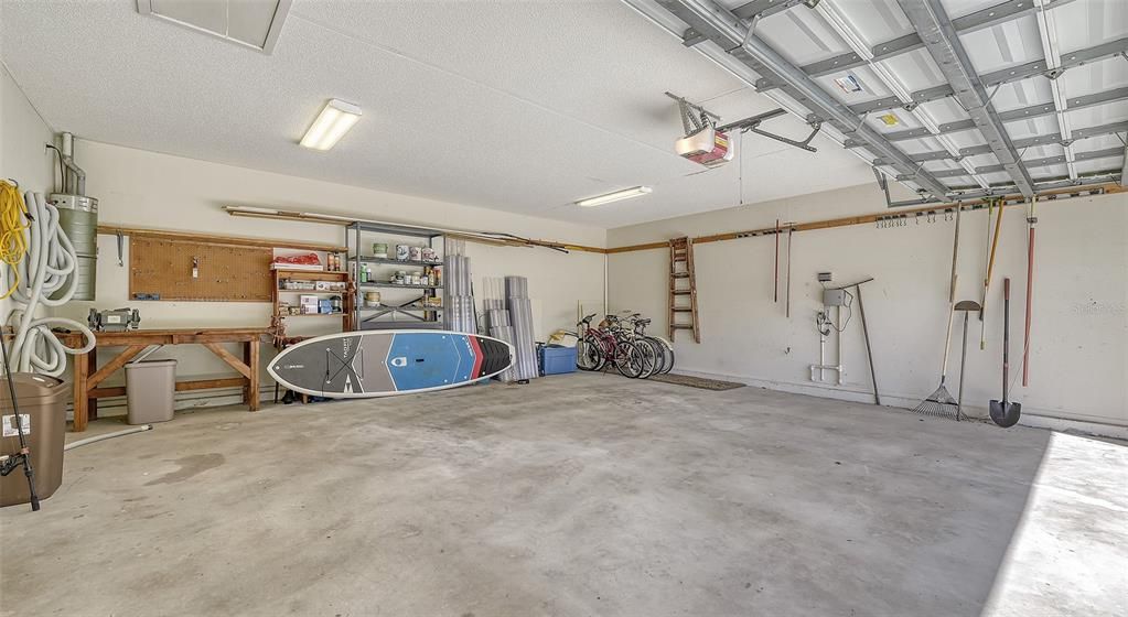 Large garage with a workbench and plenty of storage space.