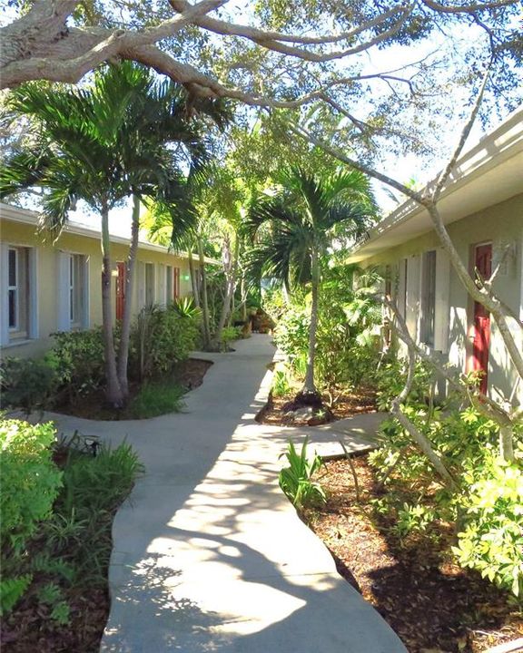 Tropical entrance pathway, unit 1st door on right.