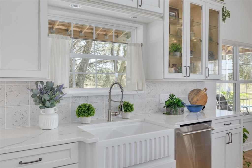 porcelain sink and a view plus glass inserts in cabinets