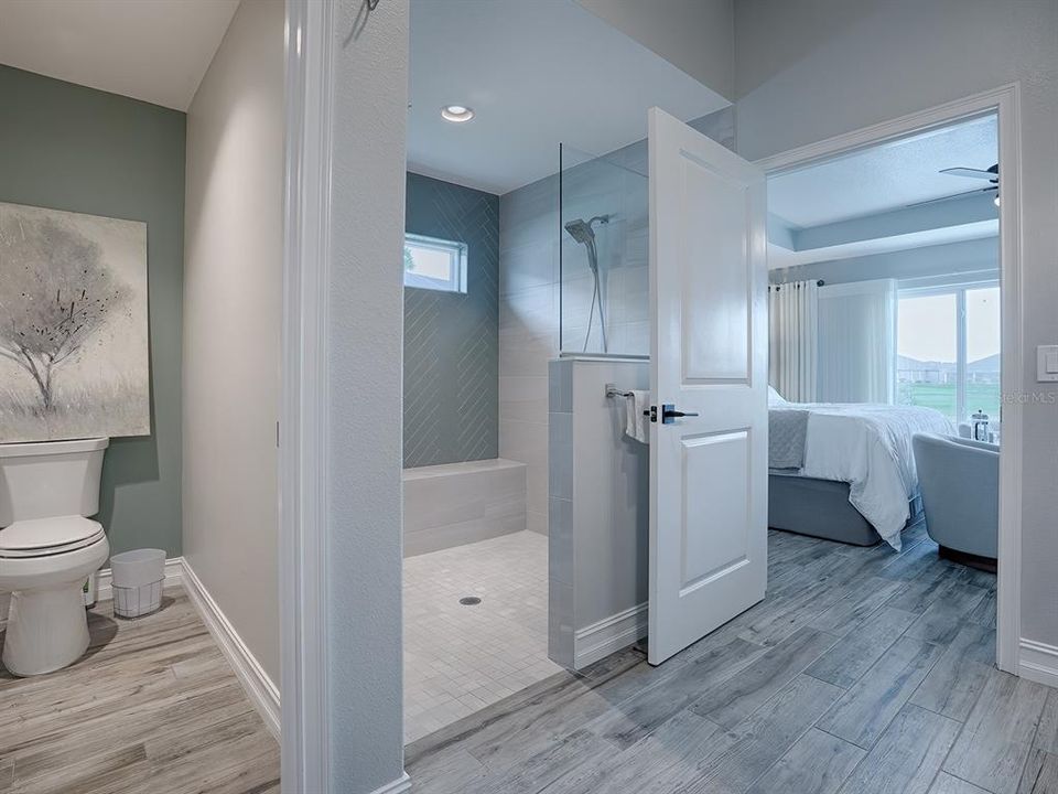 BEAUTIFULLY TILED WALK-IN SHOWER AND SEPARATE TOILET ROOM.