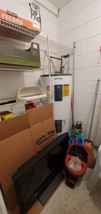 Utility Room with hotwater heater & strorage.