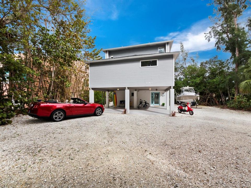 This elevated Key West style home is a haven of seclusion, featuring plenty of parking space to accommodate you, your guests, and your watercrafts for a complete coastal retreat.