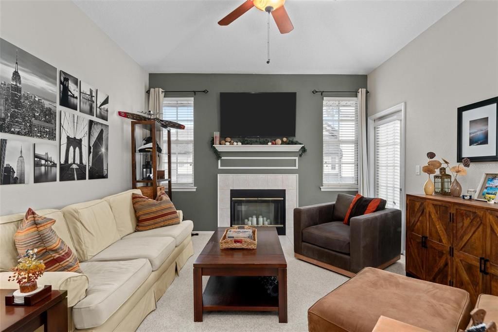 Living room w/ fireplace and balcony access