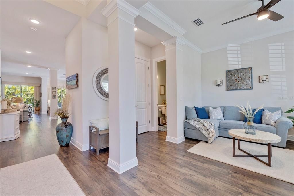 10-11 ft volume ceilings throughout and crown moulding accents create an elegant coastal feel.